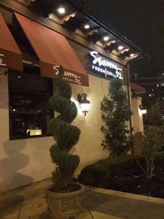 A restaurant with a red awning featuring Seasons 52 Winter Menu.