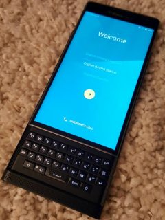 The blackberry PRIV is sitting on a carpet.