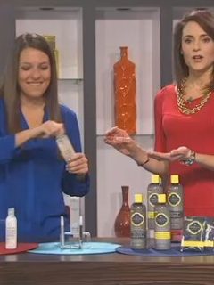 Two women showcasing cosmetic bottles to help you look your best in the New Year.