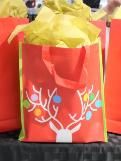 A group of red and yellow jcpenney bags with a deer on them.