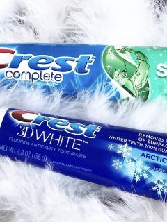 Two tubes of crest complete toothpaste on a furry background, with a crest coupon visible.