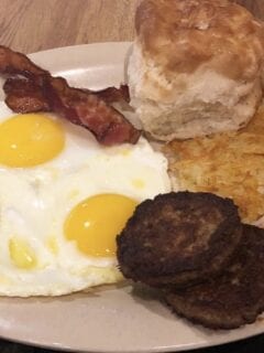 An IHOP breakfast platter with eggs, bacon, biscuits and gravy.