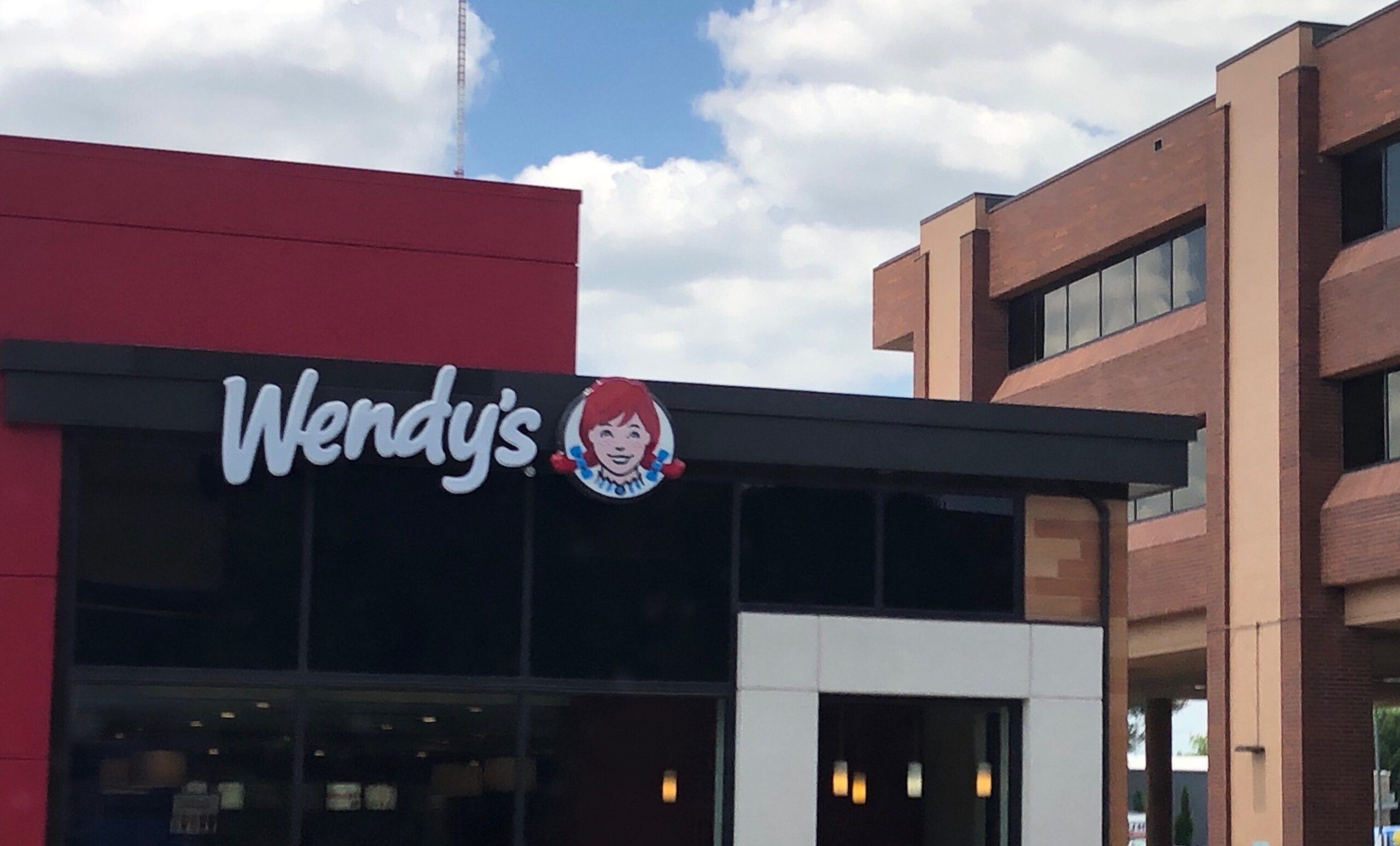 A Wendy's restaurant in front of a building, serving Weight Watchers options.