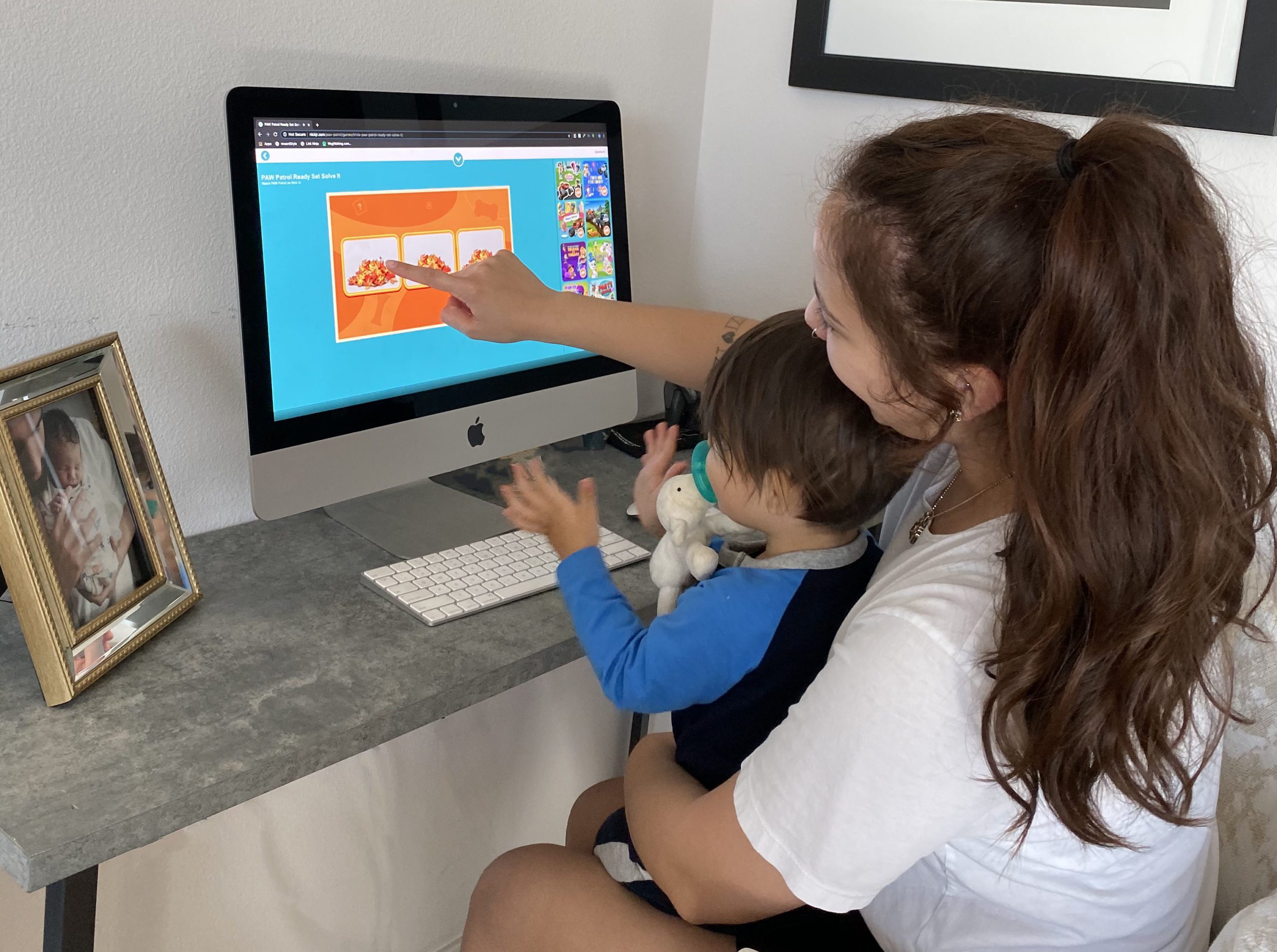 A woman and child enjoying free educational activities on a computer.