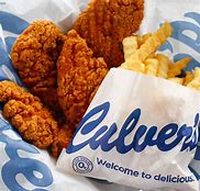 A calorie guide for Culver's including a bag of fried chicken and french fries on a table.