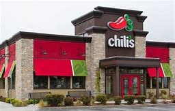 A Chili's restaurant with red awnings offering a Low Calorie Guide.