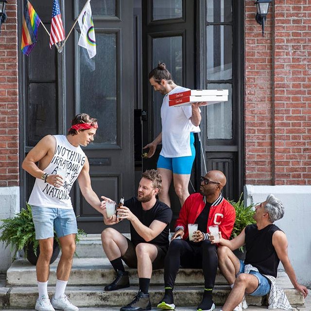 A group of men sitting on the steps of a house in 'Queer Eye' Season 5.
