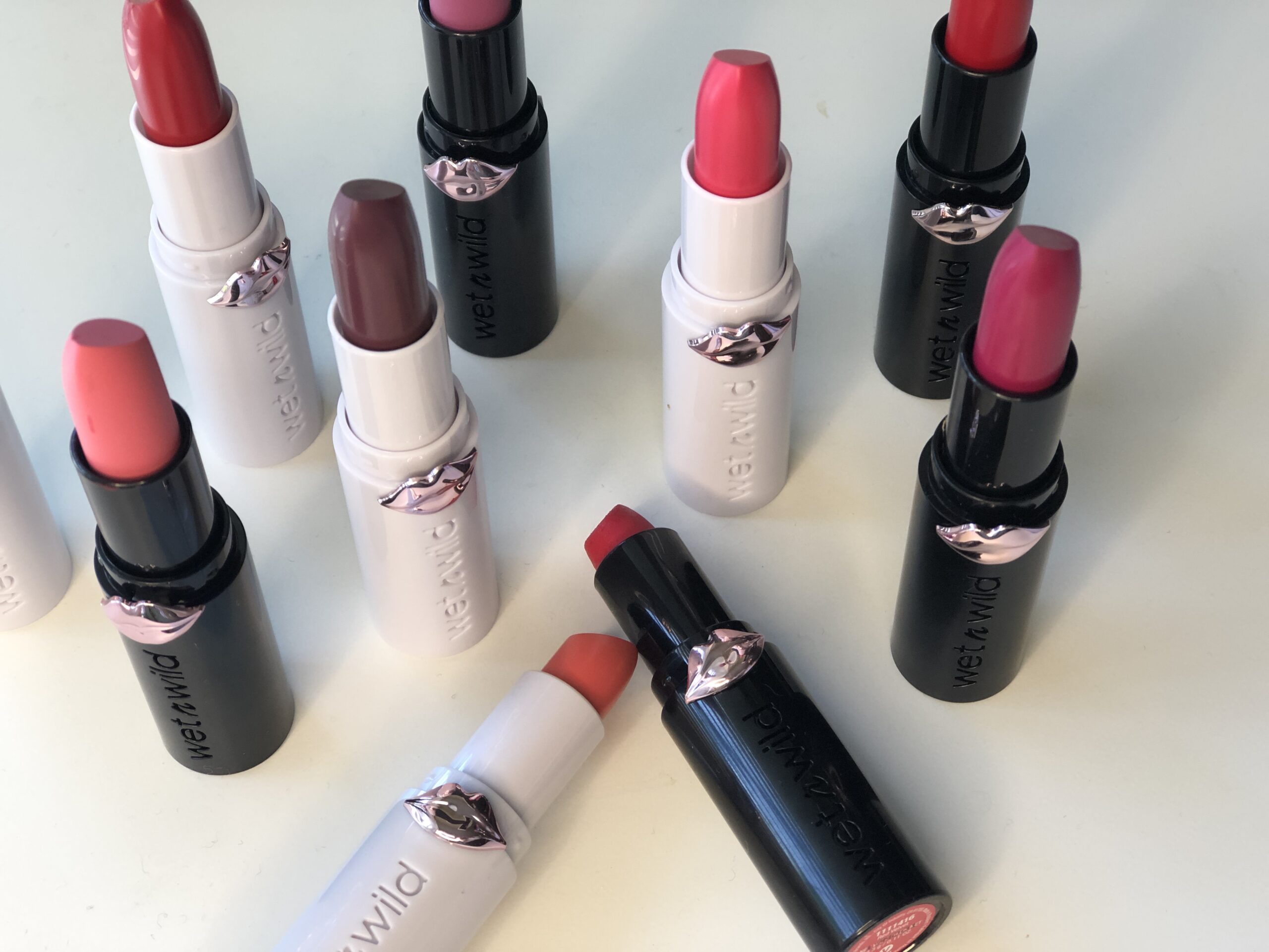 A collection of Wet 'n Wild Mega Last Lip Colors displayed on a pristine white surface.