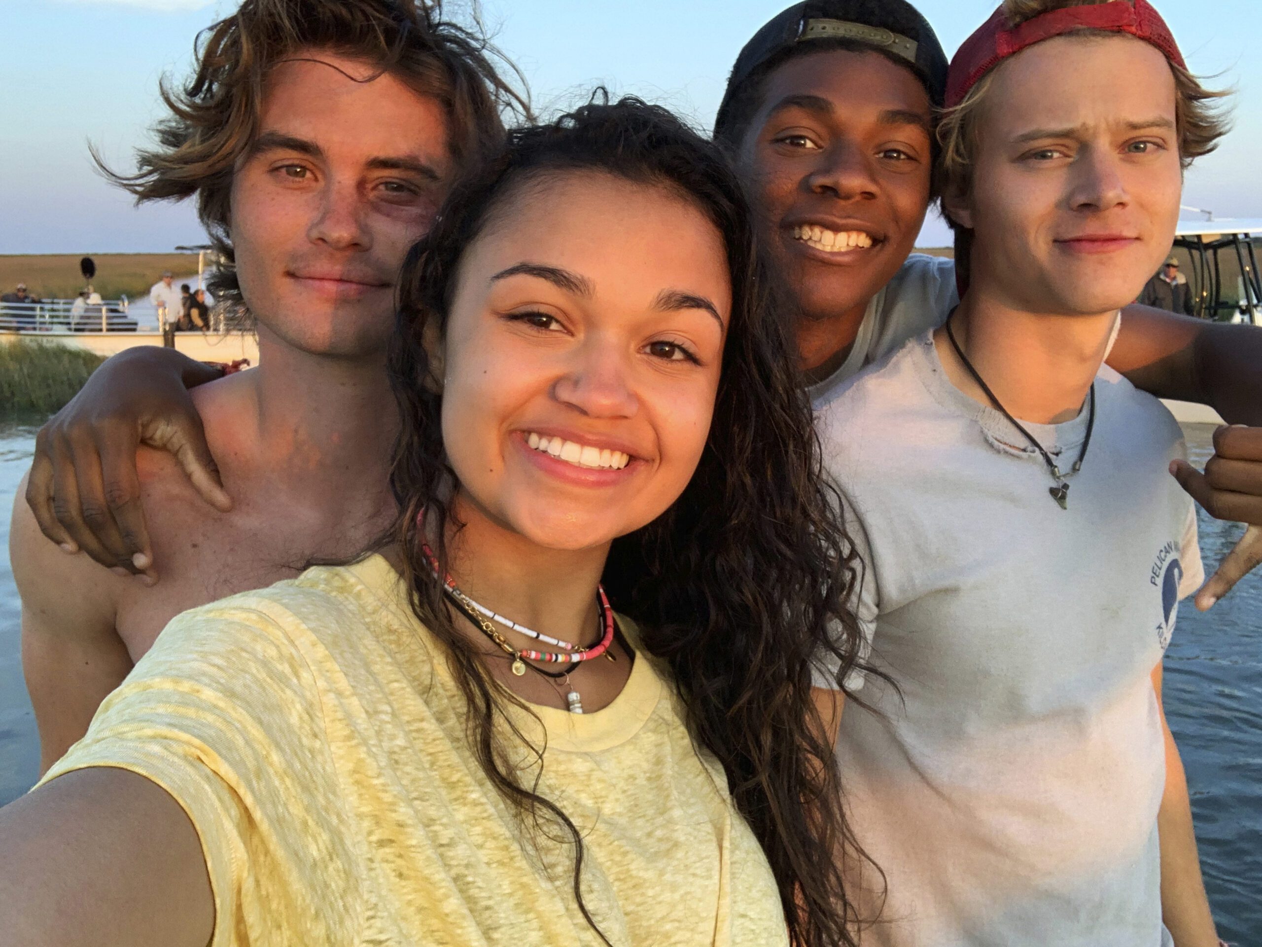 A group of young people on the beach, capturing a selfie in Outer Banks Season 2.