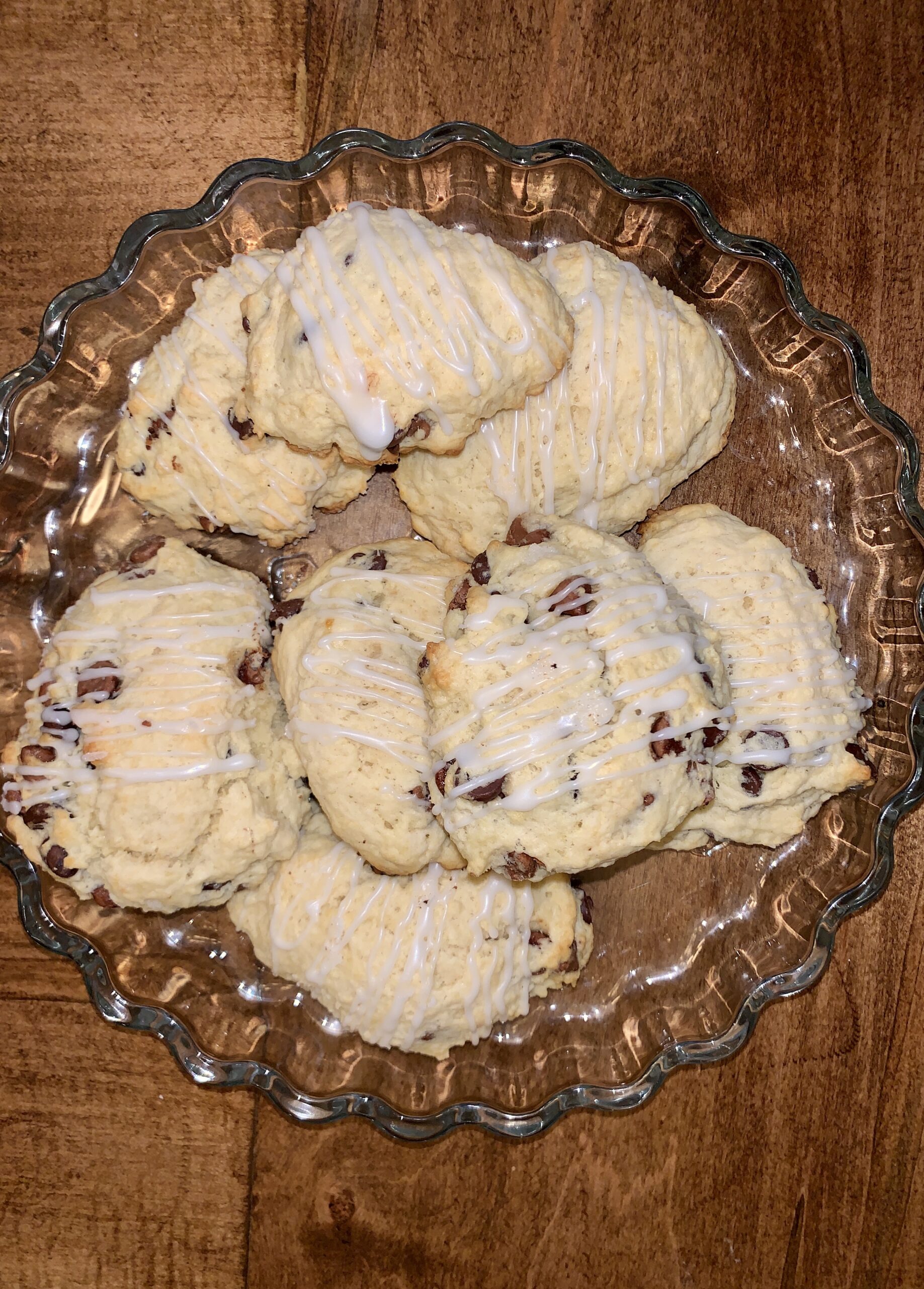 A plate of chocolate chip cookies with icing on it.