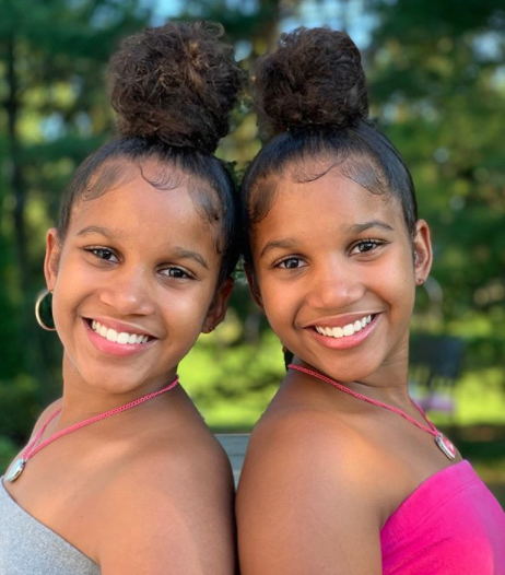 Two young girls smiling for the camera.