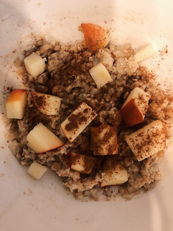 A hearty bowl of oatmeal with a touch of apple and cinnamon.