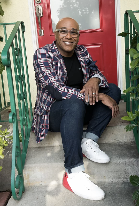 Robert, a black man, sitting on the steps of a house.