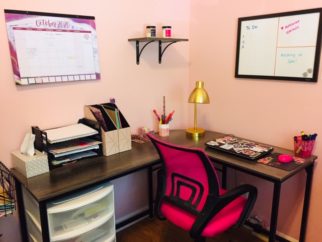 A pink workspace with a pink chair.