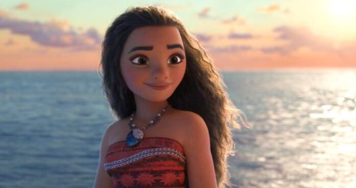 Disney's Moana is standing on a boat in front of the inspiring ocean.
