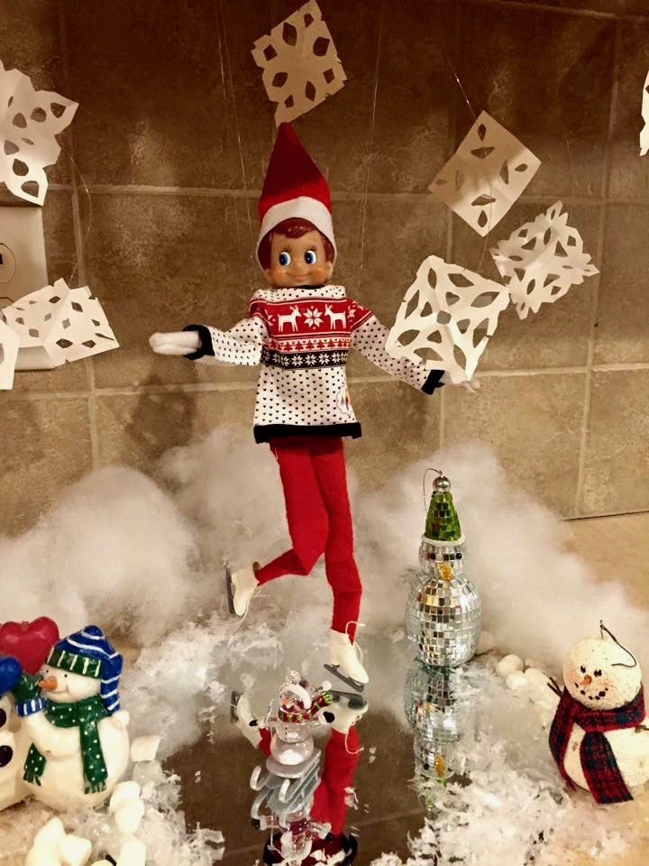 An elf on the shelf is showcasing creative ideas through its reflection in a mirror.