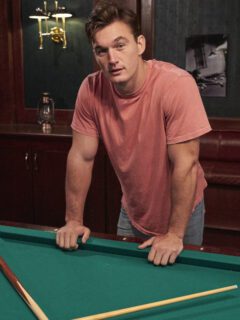 A favorite bachelorette contestant leaning over a pool table.