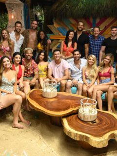 A group of people posing for a picture on a beach during Bachelor in Paradise.