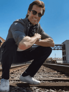 A Bachelor Nation member, Bennett Jordan, crouching down on a train track.