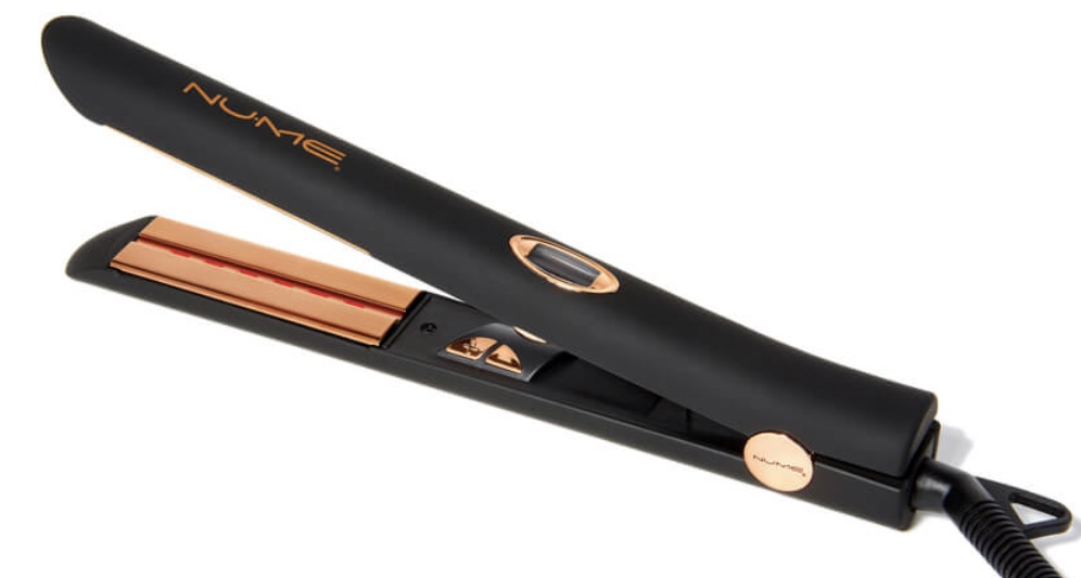 The NuMe flat iron is a matte black color with orange metallic accents. There is a small digital screen on the top, and controls located on the inside. 