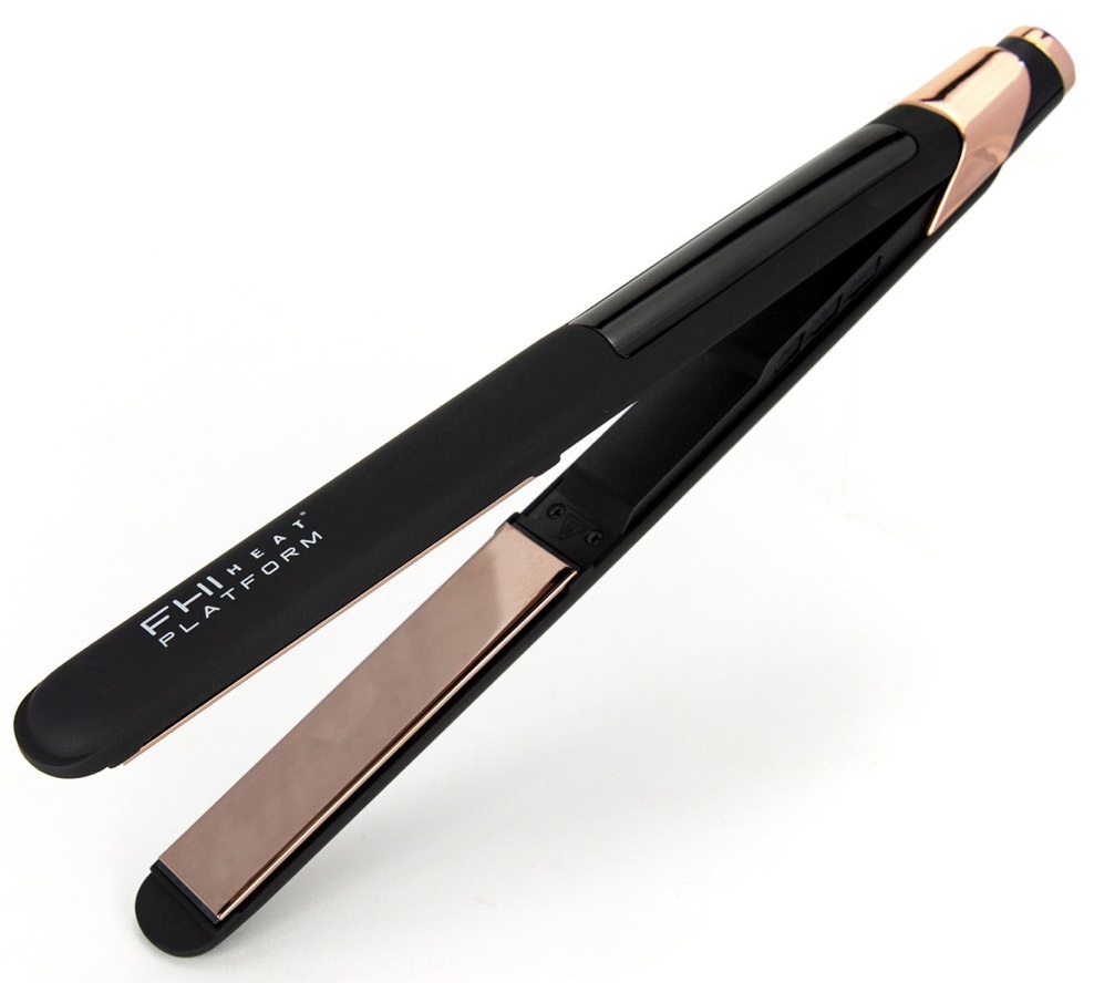 FHI Heat is a black flat iron with rose gold accents. There is a long digital screen on top.