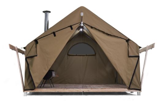 The Diamond Brand's Hestia Canvas Wall Tent is pictured. This tent is brown and has wooden floors, along with wooden beams on either side of the structure. 