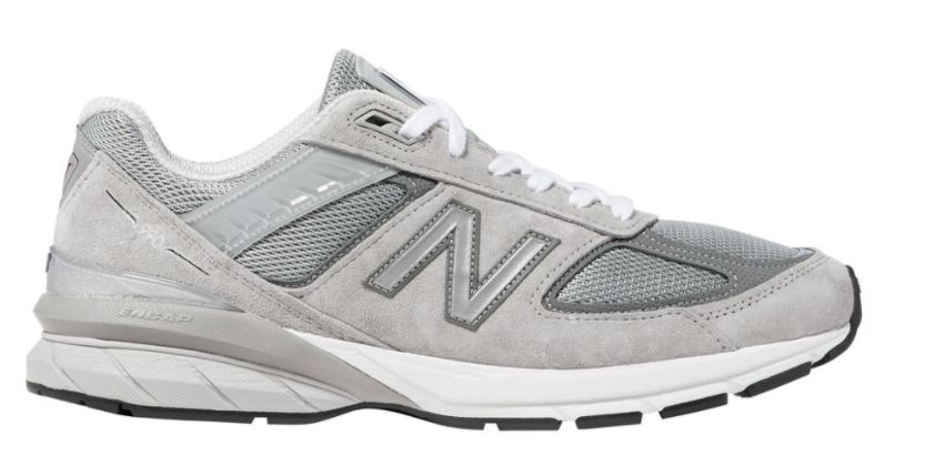 The New Balance 990v5. This retro-looking shoe is grey with a white sole. 