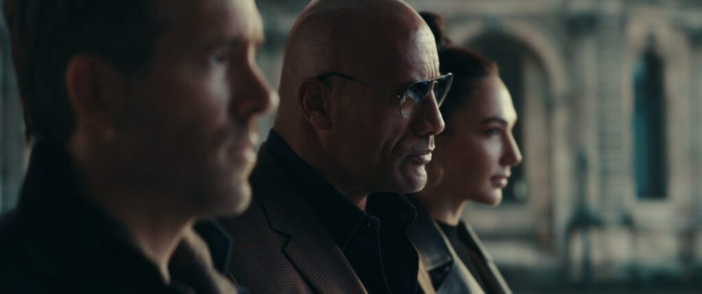 (L to R) Ryan Reynolds as Nolan Booth,  Dwayne Johnson as John Hartley and  Gal Gadot as The Bishop in Red Notice
