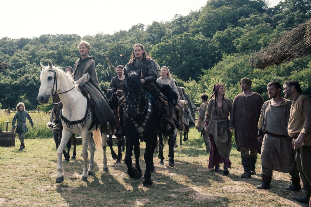 Alexander Dreymon as Uhtred of Bebbanburg and cast members of The Last Kingdom