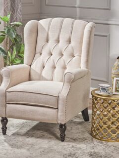 A beige upholstered chair in the living room, perfect for neck and back pain relief.
