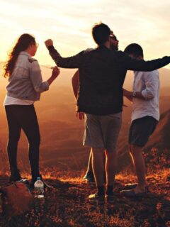Keywords: friends, mountain, sunset

Revised Description: A group of friends enjoying a gorgeous sunset on top of a mountain.