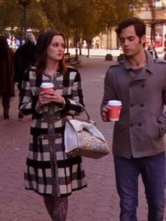 A couple strolling with coffee in hand.