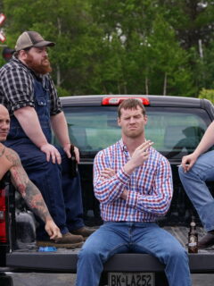 A group of men sitting in the back of a truck exchanging hilarious Letterkenny quotes.