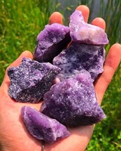 Purple amethyst crystals for inner peace in a person's hand.