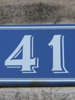A blue house sign with the number 41 on it, representing its significance in numerology.