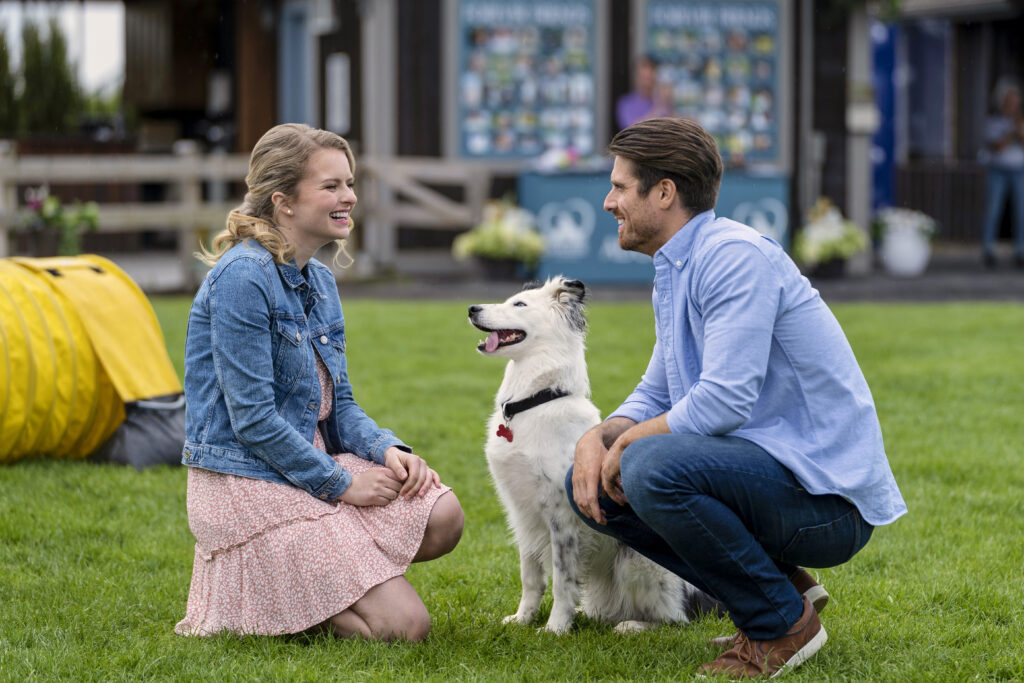 hallmark couple laughing with dog