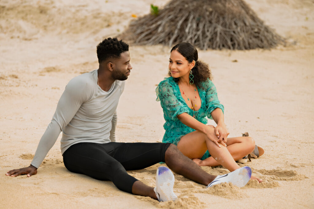 Caleb (Sinqua Walls) and Erica (Christina Milian) chat on the beach about their individual futures. 
Resort To Love