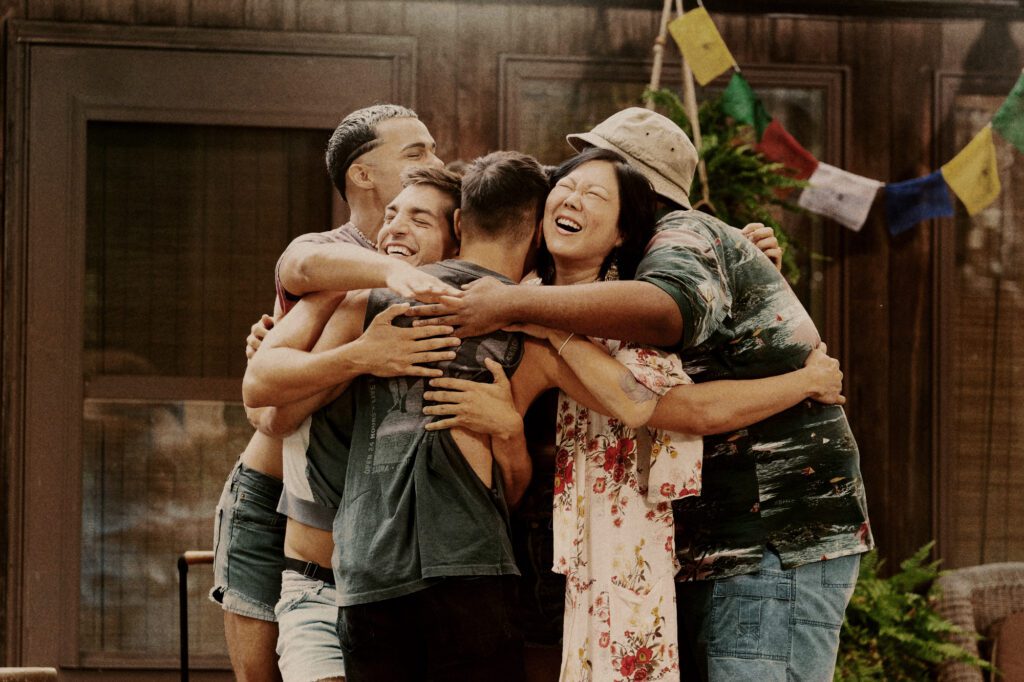 queer friends hugging fire island