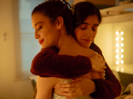 Irene and Aurora in an embrace dancing on glass