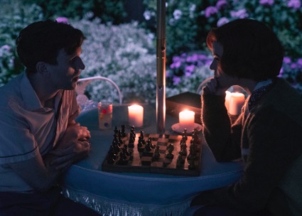 Harry and Beth playing chess outside the queen's gambit