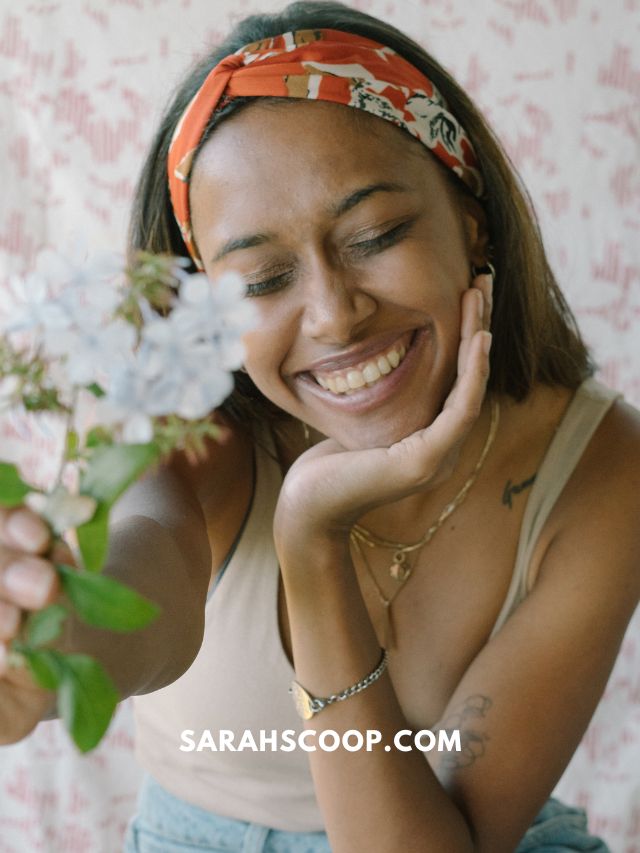 most powerful manifestation method: girl smiling with flower