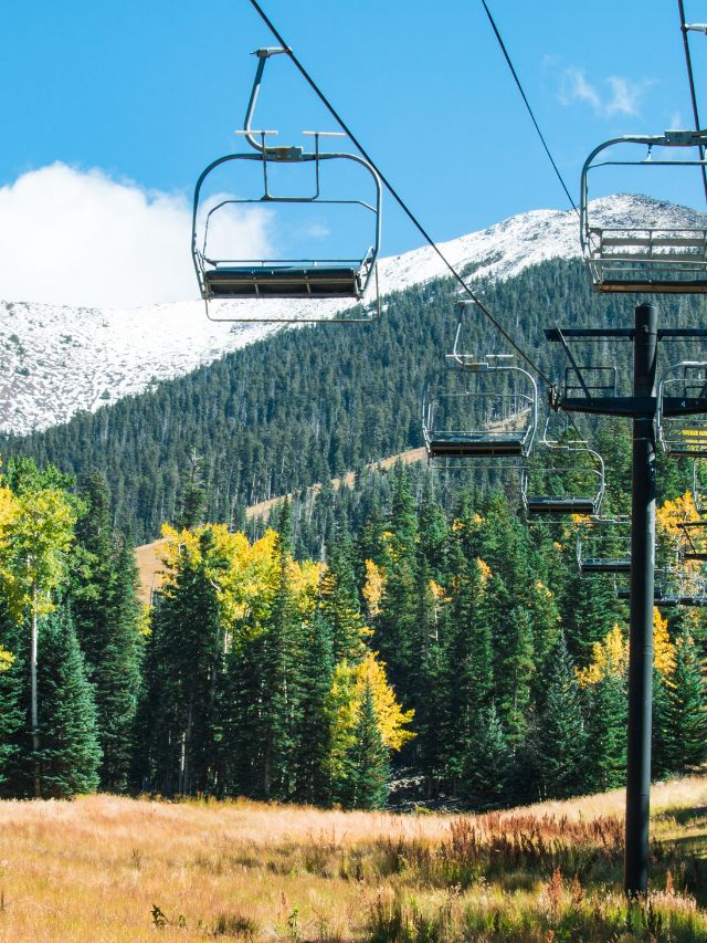 ski lifts with white capped mountain in arizona 