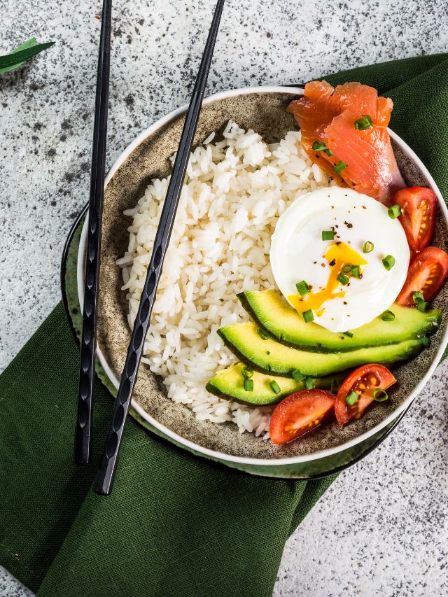 salmon rice bowl with tomatoes, egg, and avocado slices