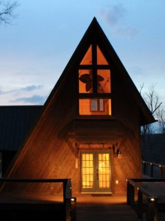 a-frame design cabin glowing at night