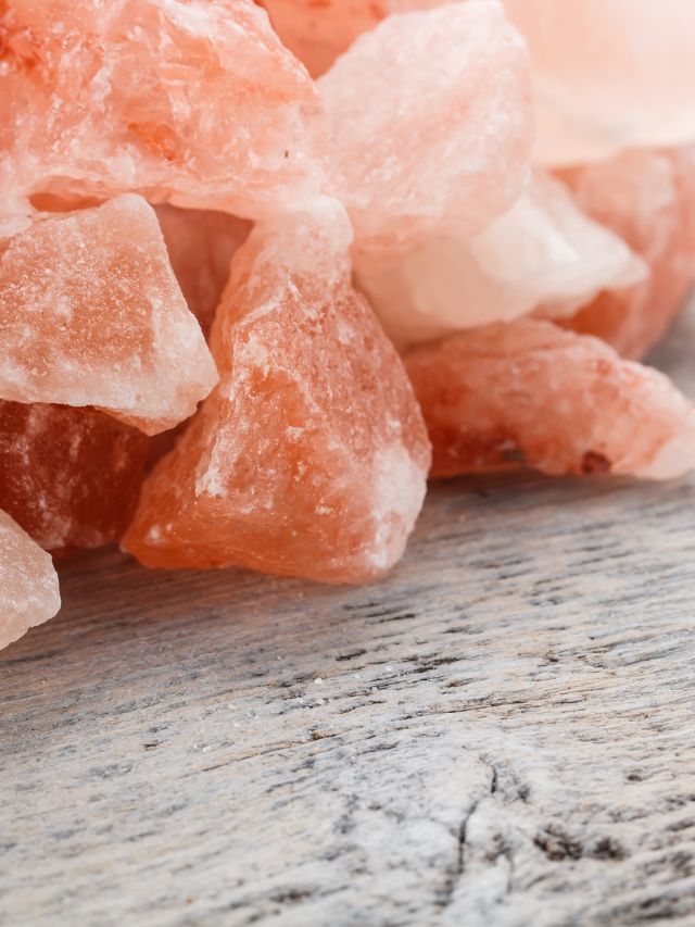Himalayan pink crystal on wooden background 