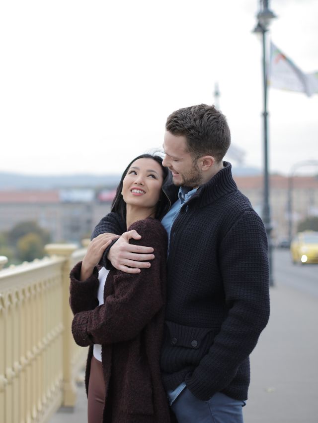 Couple on bridge embracing