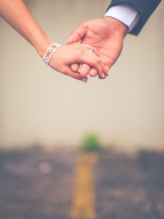 photo of man and woman holding hands