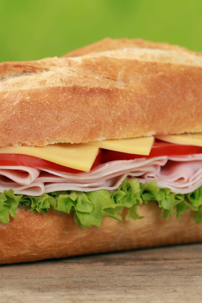 deli sub sandwich with meat cheese tomato and lettuce