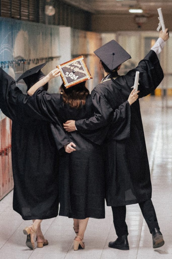 graduates celebrating in hallway