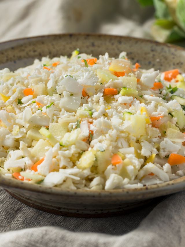 raw organic white cauliflower rice in a bowl